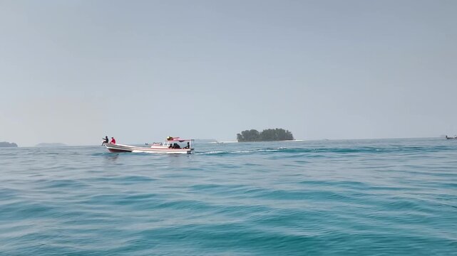 Small wooden boat sailing peacefully near island in sea
