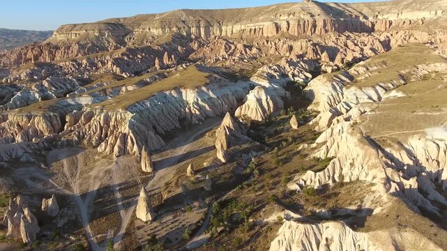 Aerial views sweep across Cappadocia fairy chimneys, valleys, and eroded tuff landscapes.