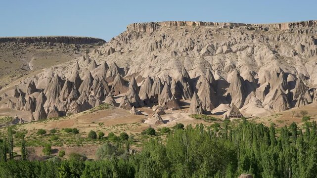 Aerial views sweep across Cappadocia fairy chimneys, valleys, and eroded tuff landscapes.
