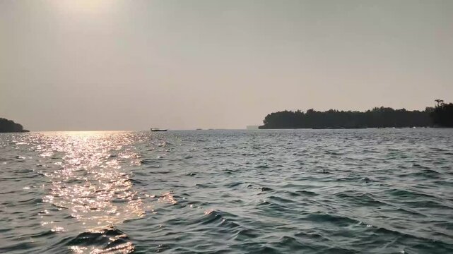 Sunset light reflection illuminating calm sea water surface