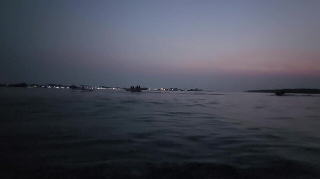 Ocean horizon line during dusk with soft clouds and islands