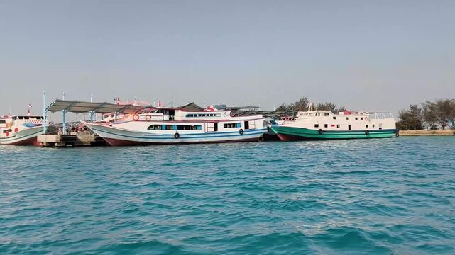 Jakarta, Indonesia - April 24, 2026: Wooden motorboats sailing fast near island coastline