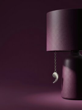 Plush bedside lamp with semicolon charm in moody purple light