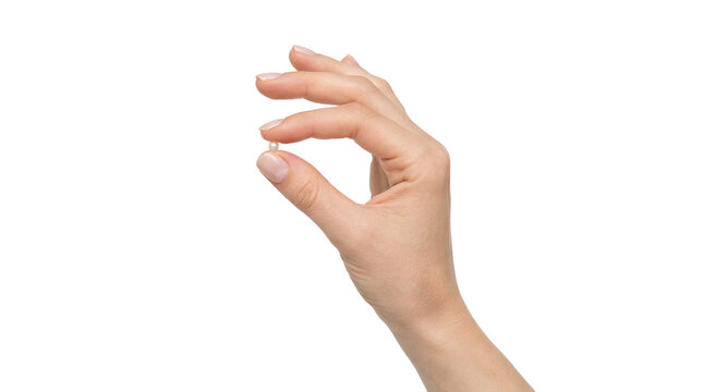 A close-up of a human hand holding a small object for concept of precision and accuracy.