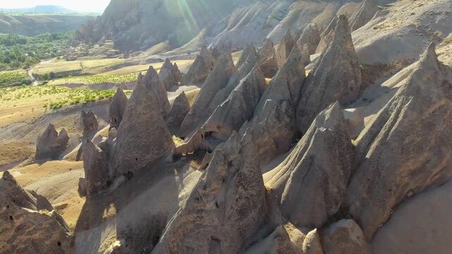 Aerial views sweep across Cappadocia fairy chimneys, valleys, and eroded tuff landscapes.