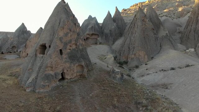 Aerial views sweep across Cappadocia fairy chimneys, valleys, and eroded tuff landscapes.