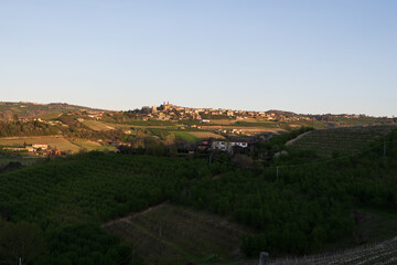Obraz premium Langhe Vineyards and Hilltop Village at Sunset