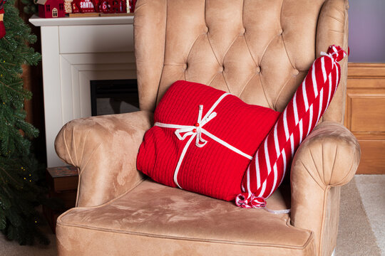 Cozy armchair with festive Christmas gifts and decorations for the holidays