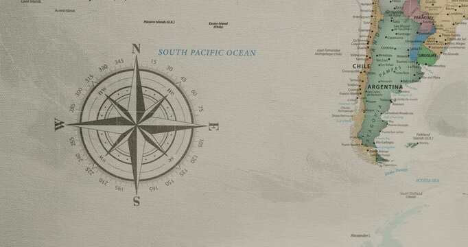 Close-up of a vintage-style political map showing the countries of South America, specifically Argentina and Chile, next to the South Pacific Ocean with a detailed compass rose for navigation