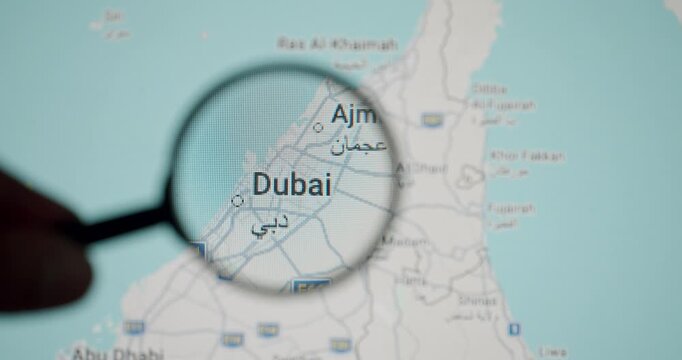Magnifying glass focusing on Dubai on a map of the United Arab Emirates, illustrating a travel destination search, geography study, or trip planning for a vacation in the Middle East