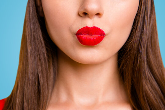 Close up half face portrait of young woman with red lips sand a kiss isolated on bright yellow background