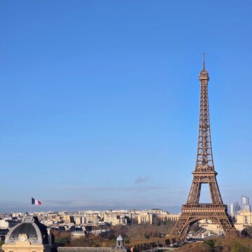 Eiffel Tower Rising Above Historic Ecole Militaire and Paris Rooftops in Morning Light