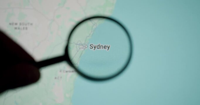 Person with a magnifying glass zooming in on the city of Sydney, Australia on a digital map, symbolizing research, travel planning, and exploration of this major oceanian destination
