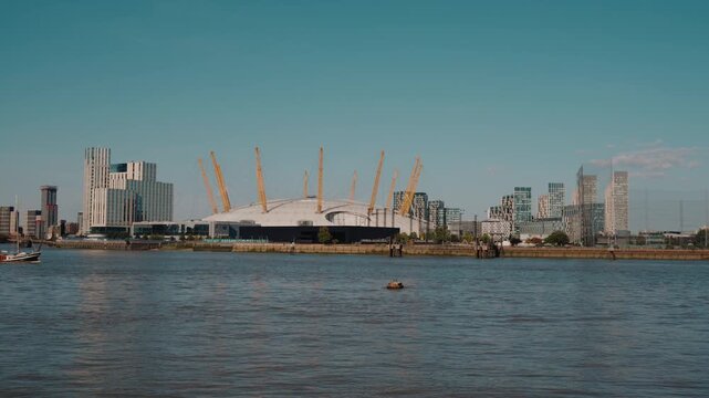 Aerial view of the River Thames in London, with The O2 entertainment complex on Greenwich Peninsula and the Canary Wharf business district visible in the background London, England - 28 August 2026.