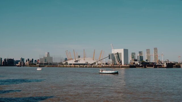 Aerial view of the River Thames in London, with The O2 entertainment complex on Greenwich Peninsula and the Canary Wharf business district visible in the background London, England - 28 August 2026.