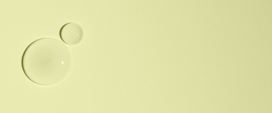 Cosmetic transparent product on a yellow background. A serum or gel or cream.