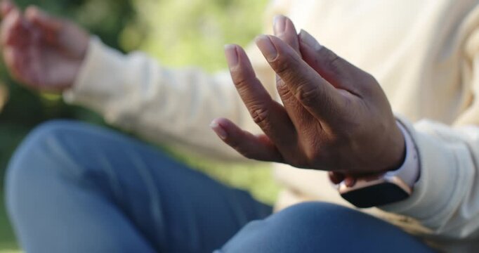 Right hand is forming mudra on lap in sunny park, smartwatch visible as meditation is starting