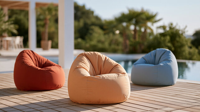 Outdoor bean bag chairs in waterproof fabric scattered on composite decking beside pool, no people, colorful accessory styling detail, garden furniture product marketing and