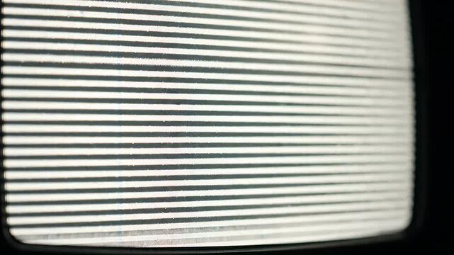 Horizontal Lines on Vintage Television Screen - A close-up view of a vintage television screen displaying static with distinct horizontal lines.