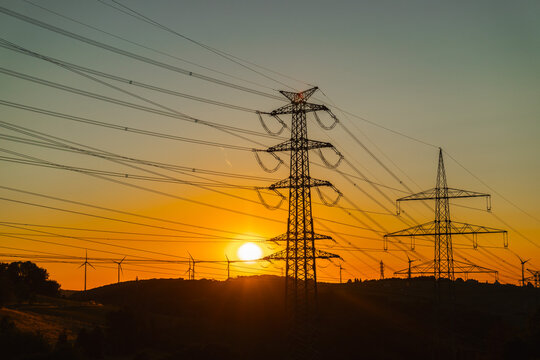 Electricity Pylons and Wind Turbines at Sunset in Germany