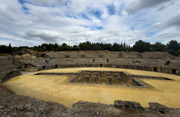 Obraz premium The arena in the amphitheater of Italica, an archaeological site at the outskirts of Seville 