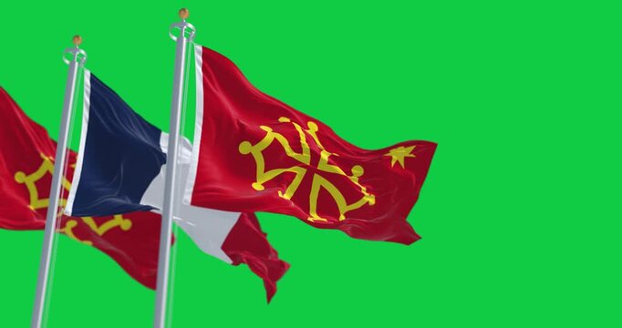 Flags of Occitanie region and France waving isolated on green background
