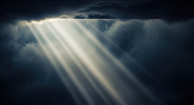 Dramatic sun rays breaking through dark storm clouds.