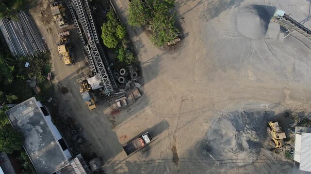 Aerial view of construction site with heavy machinery in Indonesia.