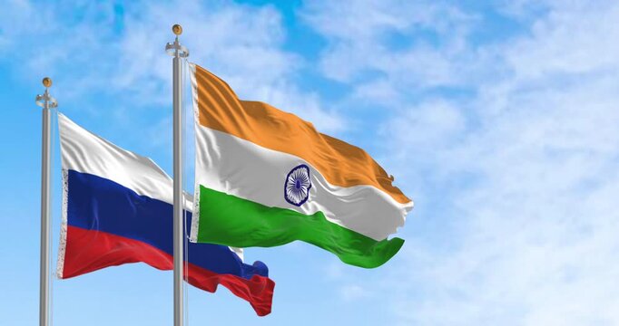 The flags of India and Russia waving in the wind on a clear day