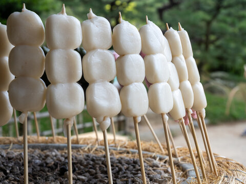 Traditional Japanese dango skewers with white mochi rice dumplings selling outdoors