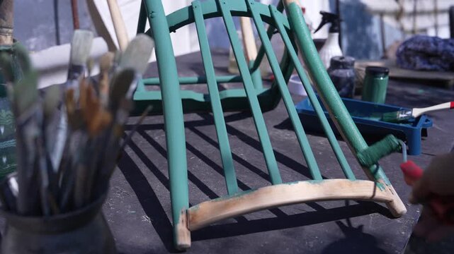 Woman Painting Wooden Chair in Workshop