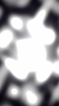 Vertical monochrome white fluid metaballs merge and deform smoothly against black contrast in a minimalist 3D animation