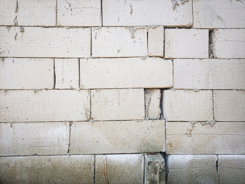 Unfinished white concrete block wall background texture for building construction