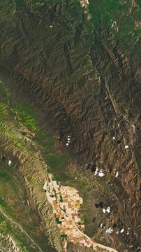 Aerial perspective on  deforestation in hilly areas. Camera is zooming in, rotating counterclockwise. Vertical video. Animation based on image by NASA