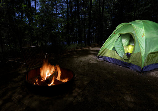Darkness coming over the campsite with a tent and fire going
