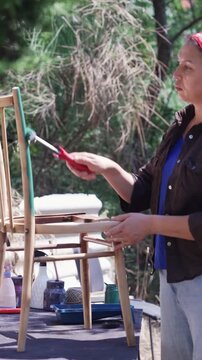 Woman Upcycling Old Furniture with Paint