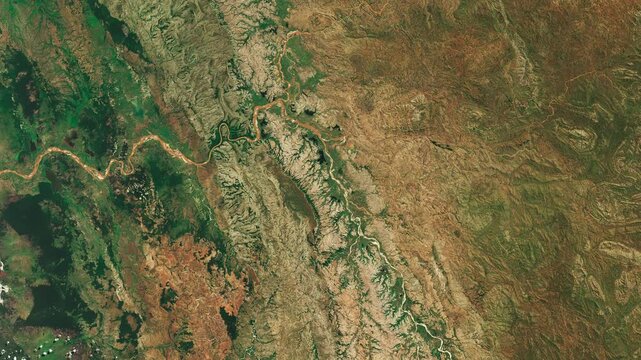 Top view on meanders of river in moderate climate. Camera is moving backward. Animation based on image by NASA