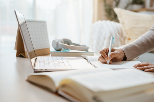 Hands write class notes as education and study and e-learning and lesson and elearning lead, then education and study and e-learning and lesson and elearning lead the current topic at a desk for now.