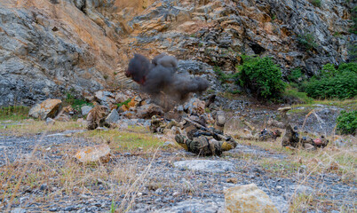 Soldiers conduct training operation in rocky area with explosions during daylight © Hip.hub