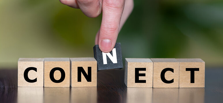 A hand places the missing N cube to complete CONNECT, symbolizing communication, connection, cooperation and bringing people together.