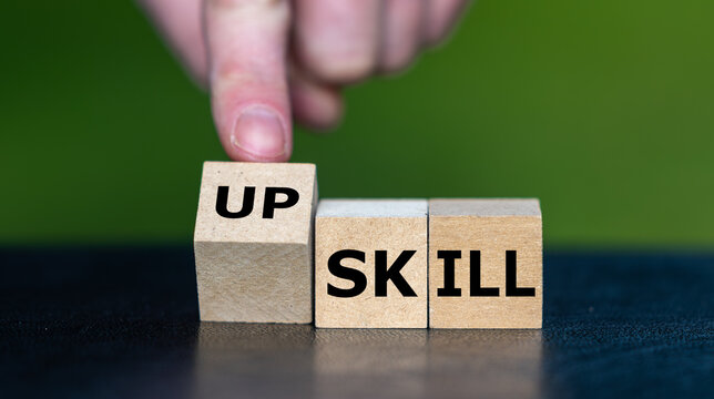 Letter cubes spell UPSKILL, symbolizing learning new skills, professional development, career growth and adapting to a changing workplace.