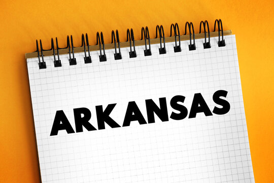 Arkansas is a landlocked state in the South Central region of the Southern United States, text concept on notepad