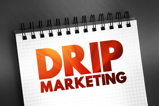 Drip marketing - communication strategy that sends a pre-written set of messages to customers or prospects over time, text concept on notepad