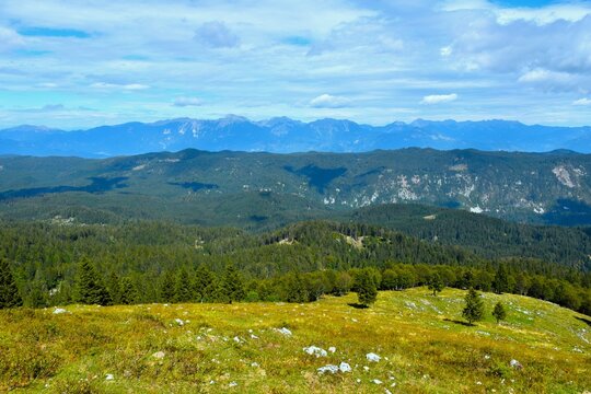 Panoramic view of Gorenjska with forest covered Jelovica plateau and Karavanke mountains in the distance in Slovenia