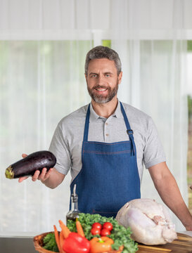 Man holding tasty baked turkey. Thanksgiving day celebration. Hispanic man cooking in kitchen. Thanksgiving dinner food. Man cooking food. Cooking turkey for Thanksgiving. Homemade dinner
