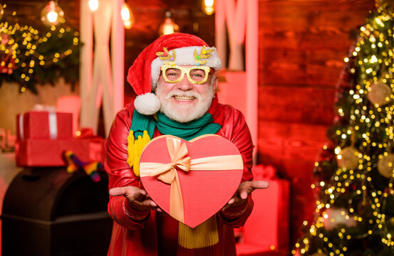 Party time. winter holiday shopping. party celebration. happy man with beard. xmas decoration. stack gifts under Christmas tree. presents from santa with love. happy new year at home