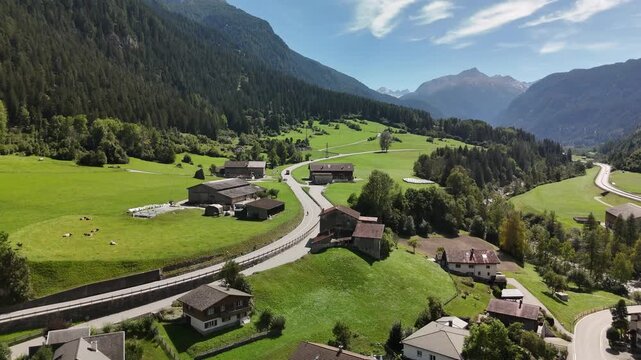 Aerial drone view of Zillis-Reischen village in the green Alpine valley of Graubunden, Switzerland
