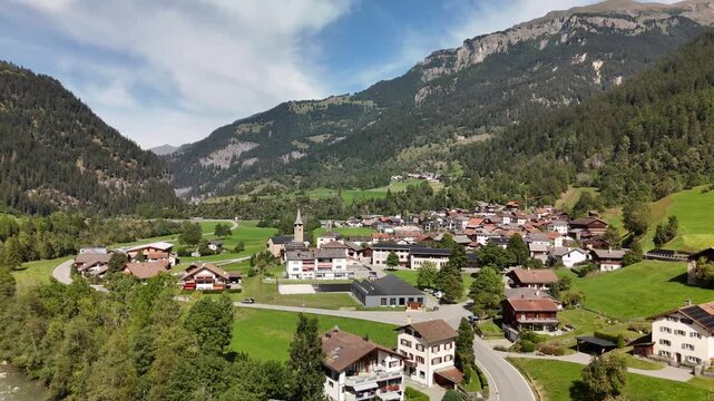 Aerial drone view of Zillis-Reischen village in the green Alpine valley of Graubunden, Switzerland