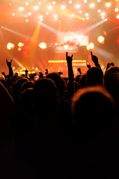 Concert audience silhouette cheering with hands up