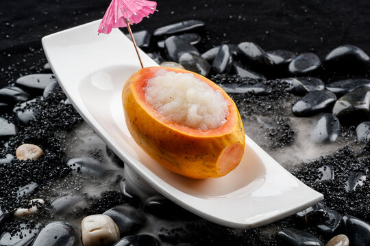 Papaya and snow frog stew was placed on pebbles surrounded by dry ice.